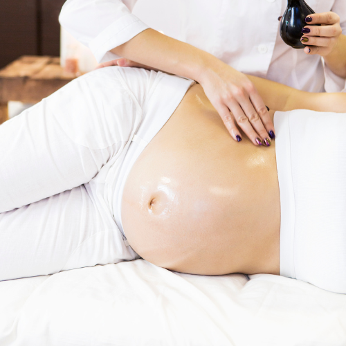 pregnancy massage being performed on a lady on her front