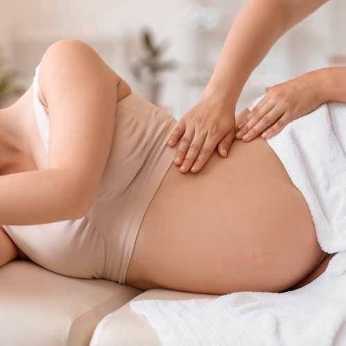 pregnancy massage being performed on a lady on her front